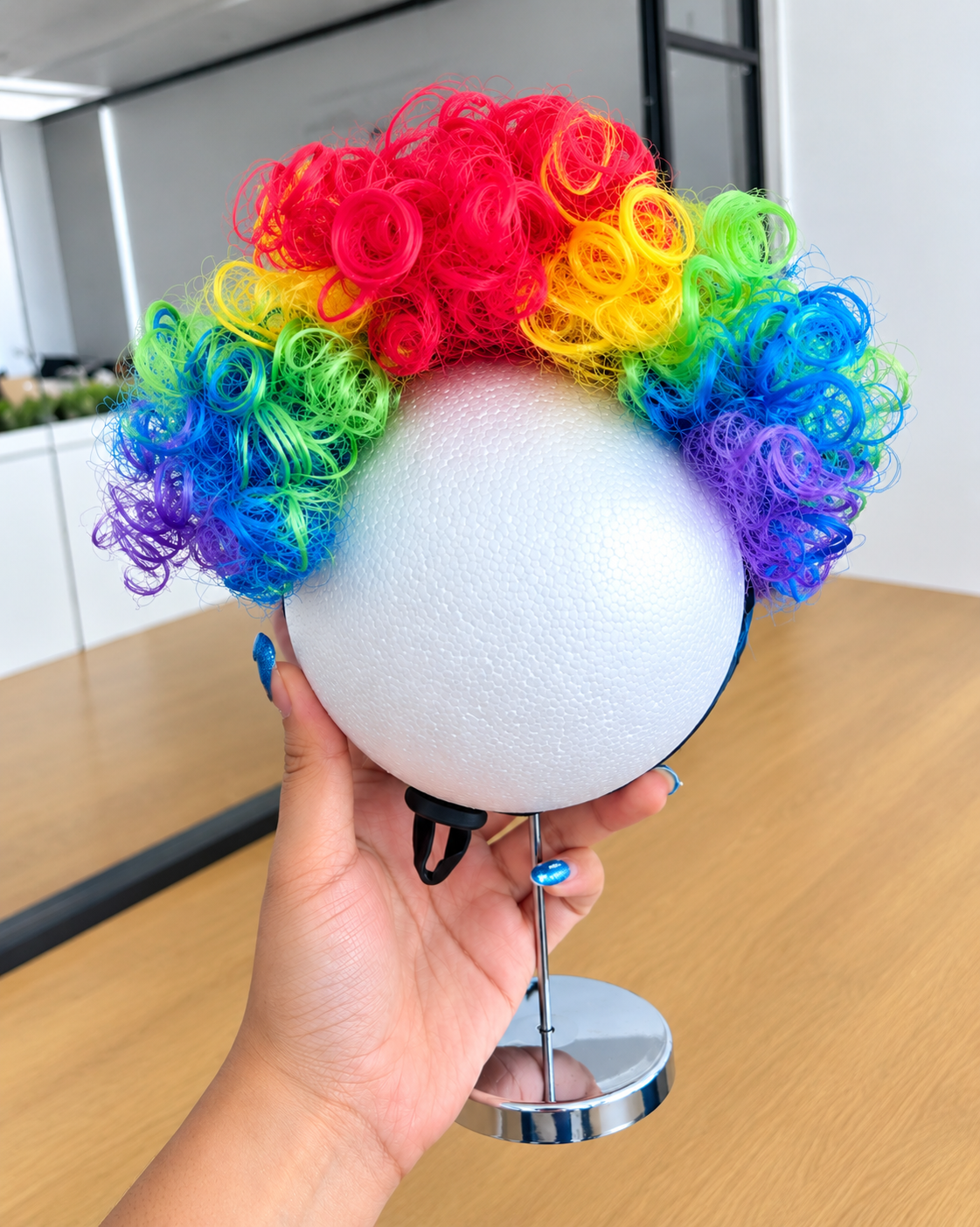 A rainbow-colored curly wig 